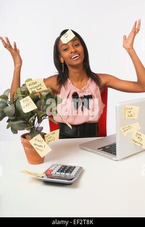 Businesswoman surrounded by sticky notes Stock Photo