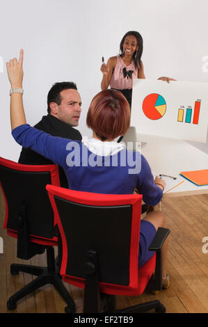 Businesswoman asking a question during an office presentation Stock Photo