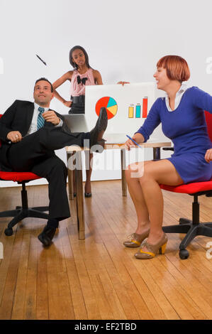 Office workers being silly during a business meeting Stock Photo