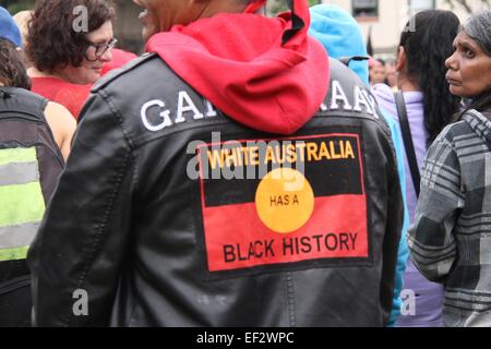 Sydney, Australia. 26 January 2015. Aboriginal Australians and their supporters marched from The Block, Redfern to Victoria Park Camperdown where they joined the Yabun event. The rally was called ‘Never Ceded! Always was Always will be Aboriginal land! Invasion Day Rally’. Pictured is a protester Victoria Park, Camperdown wearing a jacket with the words, ‘White Australia has a black history’. Credit: Copyright Credit:  2015 Richard Milnes / Alamy Live News Stock Photo