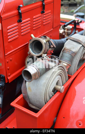 Fire brigade water hose reels on a vintage British fire engine vehicle. Stock Photo