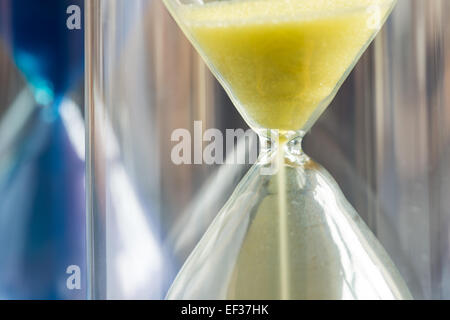 timer hourglass streaming grains of sand flowing through depicting things are running out