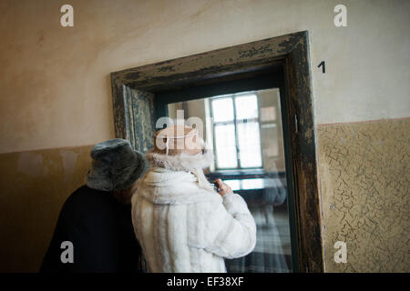 Oswiecim, Poland. 26th Jan, 2015. Visitors take pictures at the former Nazi-German concentration and extermination camp KL Auschwitz I ahead of the upcoming 70th anniversary of the liberation of the camp in Oswiecim, Poland, 26 January 2015. Photo: Rolf Vennenbernd/dpa/Alamy Live News Stock Photo