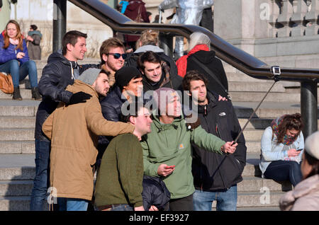 London, England, UK. Group of tourists taking a selfie with a selfie stick Stock Photo