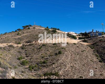 The Cross of Benidorm above Benidorm and construction in the hills Stock Photo