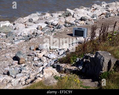 Television dumped on a beach Stock Photo