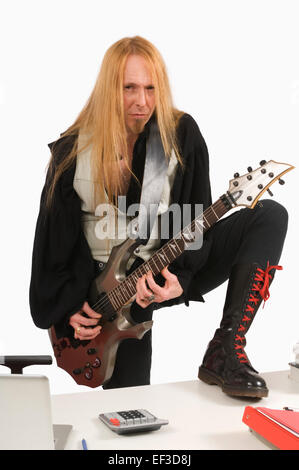 Long haired guitar player Stock Photo