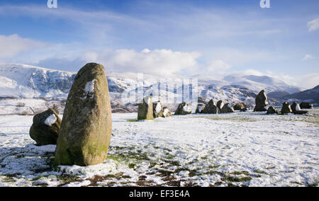 Castlerigg stone circle in front of Helvellyn mountain range in the winter snow. Lake District, Cumbria, England. Stock Photo