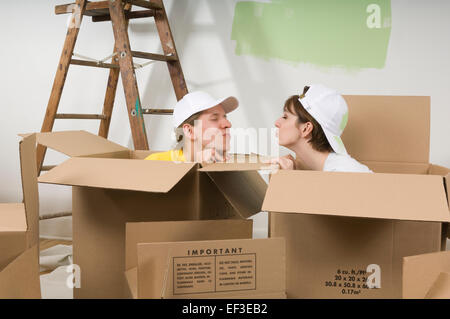 Playful couple inside cardboard boxes Stock Photo
