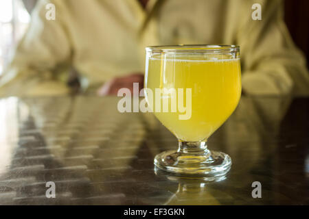 A glass of Poncha stands on a table on the island of Madeira, Portugal. Stock Photo