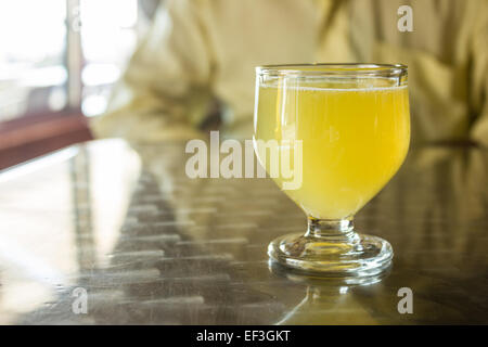 A glass of Poncha stands on a table on the island of Madeira, Portugal. Stock Photo