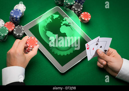 casino poker player with cards, tablet and chips Stock Photo