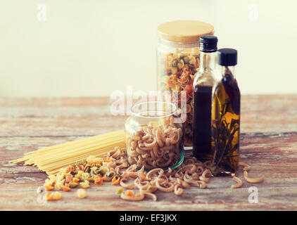 close up of two olive oil bottles and pasta in jar Stock Photo