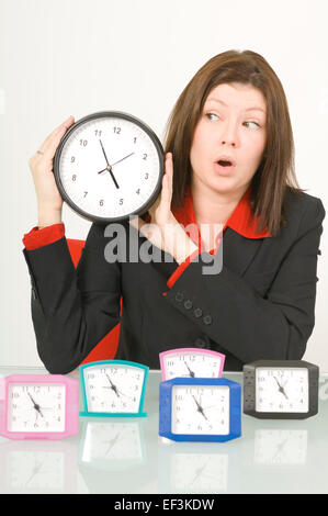 Businesswoman holding a clock Stock Photo