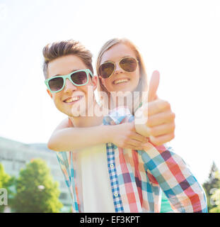 smiling couple having fun and showing thumbs up Stock Photo