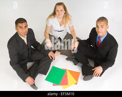 Business colleagues sitting cross legged on the floor Stock Photo