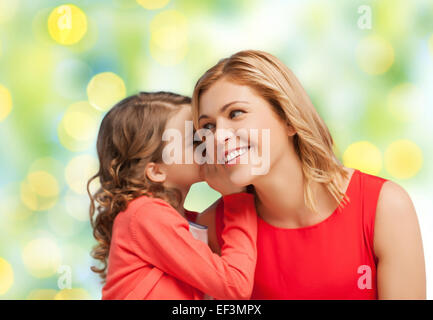 happy daughter whispering gossip to her mother Stock Photo