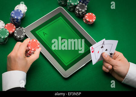 casino poker player with cards, tablet and chips Stock Photo