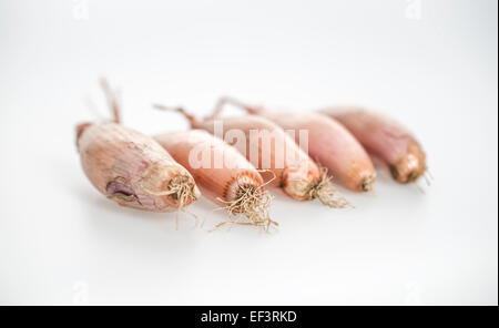 Row of shallots on white background Stock Photo