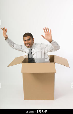 Man in a cardboard box Stock Photo