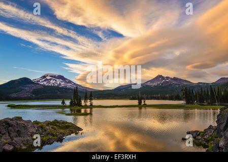 Sunset clouds over Broken Top and South Sister from Ray Atkeson Memorial viewpoint at Sparks Lake; Cascade Mountains, Oregon. Stock Photo