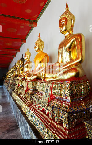 Gold statues of the Buddha abreast at Wat Pho, Bangkok, Thailand Stock Photo