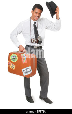 Man tipping his hat while holding suitcase Stock Photo