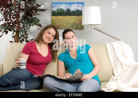 Two friends relaxing on couch Stock Photo