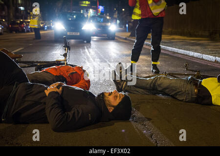 London, UK. 26th January, 2015. Cyclists lie in the road on the spot where physiotherapist Stephanie Turner was hit by a lorry and killed on the junction with Amhurst Park and Seven Sisters Road while cycling on Tuesday, 20th January. Protesters from cyclist campaigning group 'Stop The Killing' organised a vigil and 'die-in' of cyclists lying on the ground beside their bikes to symbolise road accident fatalities. Credit:  Patricia Phillips/Alamy Live News Stock Photo