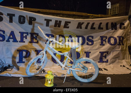 London, UK. 26th January, 2015. A white 'ghost bike' marks the spot as cyclists gather to pay their respects where physiotherapist Stephanie Turner was hit by a lorry and killed on the junction with Amhurst Park and Seven Sisters Road while cycling on Tuesday, 20th January. Protesters from cyclist campaigning group 'Stop The Killing' organised a vigil and 'die-in' of cyclists lying on the ground beside their bikes to symbolise road accident fatalities. Credit:  Patricia Phillips/Alamy Live News Stock Photo