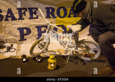 London, UK. 26th January, 2015. A white 'ghost bike' marks the spot as cyclists gather to pay their respects where physiotherapist Stephanie Turner was hit by a lorry and killed on the junction with Amhurst Park and Seven Sisters Road while cycling on Tuesday, 20th January. Protesters from cyclist campaigning group 'Stop The Killing' organised a vigil and 'die-in' of cyclists lying on the ground beside their bikes to symbolise road accident fatalities. Credit:  Patricia Phillips/Alamy Live News Stock Photo