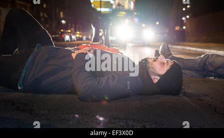 London, UK. 26th January, 2015. Cyclists lie in the road on the spot where physiotherapist Stephanie Turner was hit by a lorry and killed on the junction with Amhurst Park and Seven Sisters Road while cycling on Tuesday, 20th January. Protesters from cyclist campaigning group 'Stop The Killing' organised a vigil and 'die-in' of cyclists lying on the ground beside their bikes to symbolise road accident fatalities. Credit:  Patricia Phillips/Alamy Live News Stock Photo