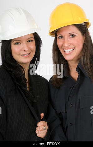 Two women wearing hard hats Stock Photo