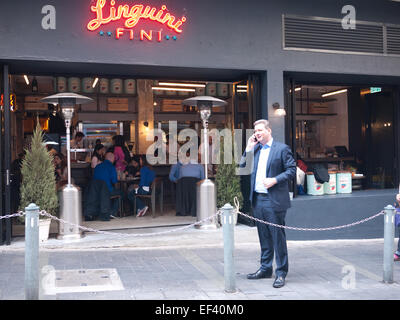 Hong Kong 2015 -  Italian restaurant man talking at phone on streets Stock Photo