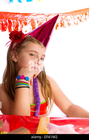 Bored gesture blond kid girl in party with birthday hat portrait on white Stock Photo