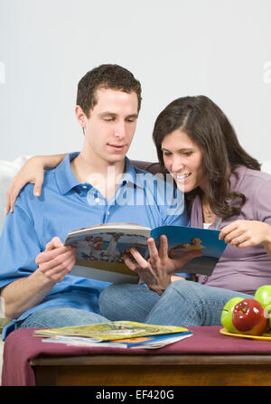 Couple looking at travel brochures Stock Photo
