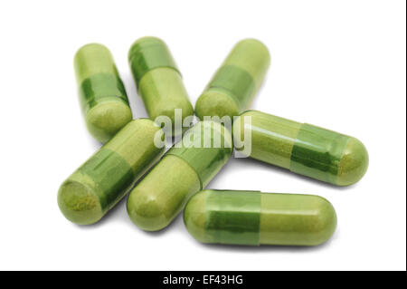 Green medical pills on white background Stock Photo