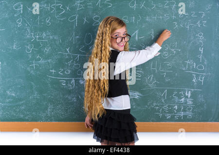 Clever nerd pupil blond girl writing in green board student schoolgirl Stock Photo