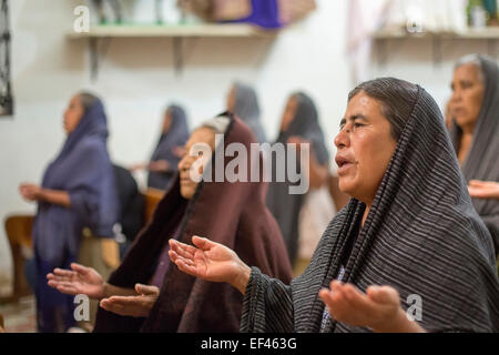 San Sebastian Abasolo, Oaxaca, Mexico - Women pray during mass at the San Sebastian Abasolo Catholic church. Stock Photo