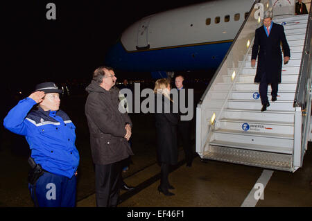 U.S. Ambassador to France Jane Hartley, French Prefect Philippe Riffault, and French Gendarmerie Captain Benhafessa Cecile wait at the bottom of the stairs as U.S. Secretary of State John Kerry arrives at Le Bourget Airport outside Paris, France, on January 15, 2015, to pay homage to the victims of last week's shooting attacks at Charlie Hebdo magazine, a pair of city streets, and a Kosher grocery store. Stock Photo