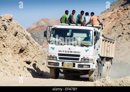 Over loaded open top truck carrying workmen to work Danakil Depression, Ethiopia,  Africa Stock Photo