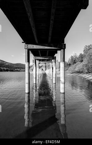 Big Bear Lake photographed under the wooden pier of the Stanfield Marsh Boardwalk in Big Bear Lake, California, USA. Stock Photo