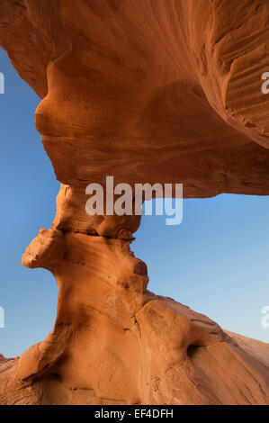 Arch Rock bends overhead in Valley of Fire, is the oldest Nevada State Park and located in the Mojave Desert. Stock Photo