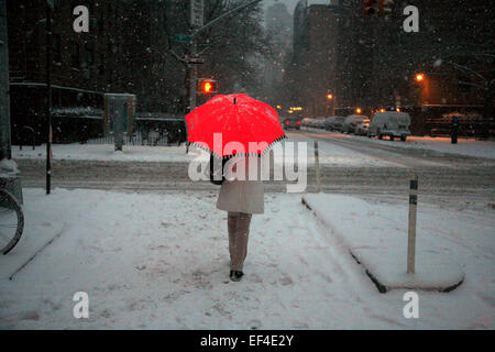 New York, USA. 26th January, 2015. A pedestrian pauses at the corner of 9th Avenue and 20th Street as snow falls in the Chelsea area of Manhattan on the afternoon of January 26th, 2015.  New York City and most of the eastern seaboard of the United States are preparing for what may be a historic blizzard with possible accumulations of 2-3 feet. Credit:  Adam Stoltman/Alamy Live News Stock Photo