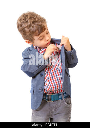 Little boy puts money in his pocket on white background Stock Photo