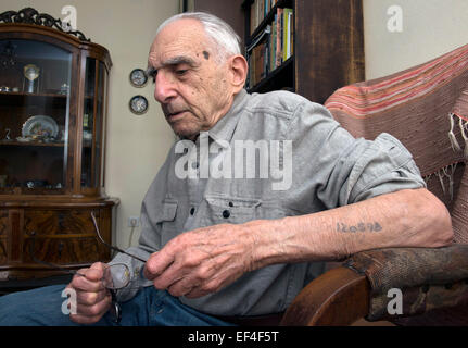 (150127) -- ZAGREB, Jan. 27, 2015 (Xinhua) -- Holocaust survivor Boris Braun shows his tattooed prisoner identification number as he speaks to journalists of Xinhua News Agency during an interview in Zagreb, capital of Croatia, Jan. 26, 2015. Boris Braun was imprisoned for two years in Auschwitz and others Nazi concentration camps. He will join Croatian delegation to attend an official ceremony marking the 70th anniversary of the liberation of the KL Auschwitz Concentration Camp in the former Auschwitz-Birkenau camp in Poland on Jan. 27. The day is also the International Holocaust Memorial Day Stock Photo