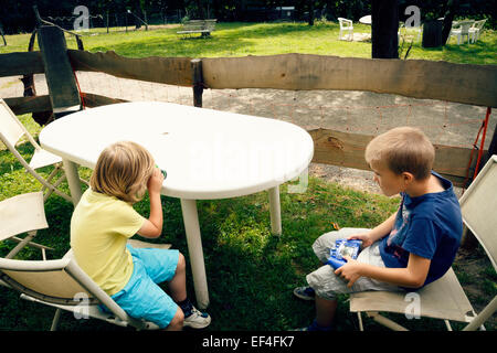 Two young boys outdoors at a park. Stock Photo