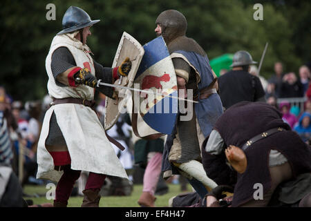 Participants dressed as soldiers taking part in a battle scene at Bannockburn Live, at Bannockburn, Stirlingshire. Stock Photo