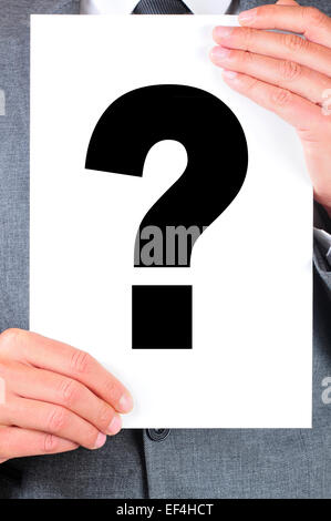 a man wearing a suit  holding a signboard with a question mark on it Stock Photo