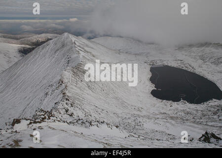 Swirrel Edge and Red Tarn from near the summit of Helvellyn on a winters day in the Lake District, Cumbria, UK Stock Photo
